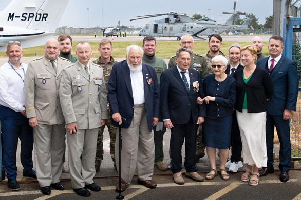 Some of the aircrew pose with the Czech veterans in front of the 845 NAS Merlins in Jersey
