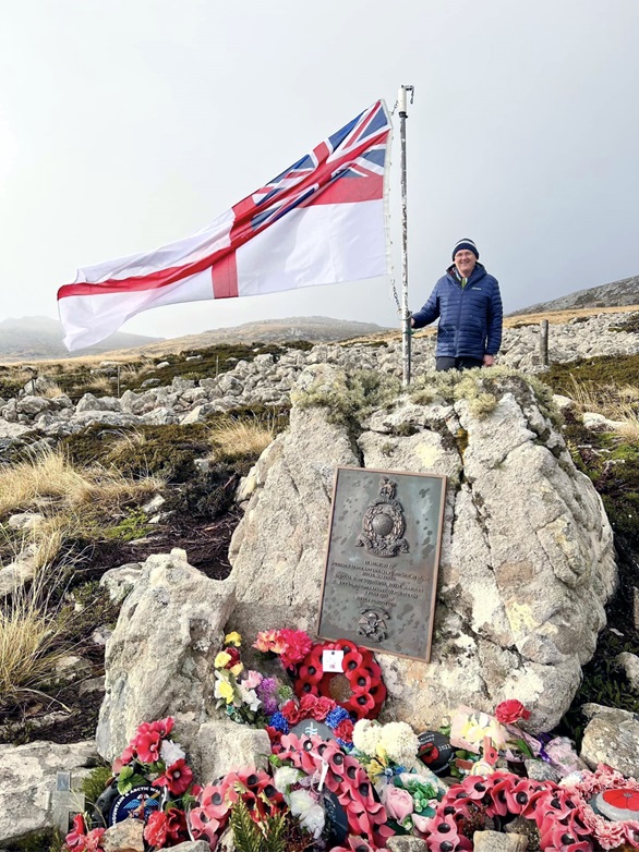 Sharkey Ward and a huge White Ensign at the memorial to Sgt Kiwi Hunt